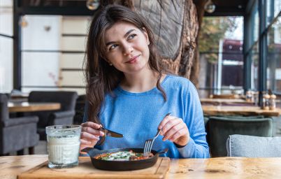 девушка ест в кафе айран